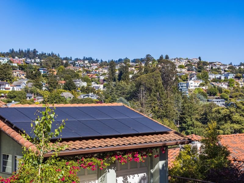 Residential home with solar panels on a terracotta tiled roof