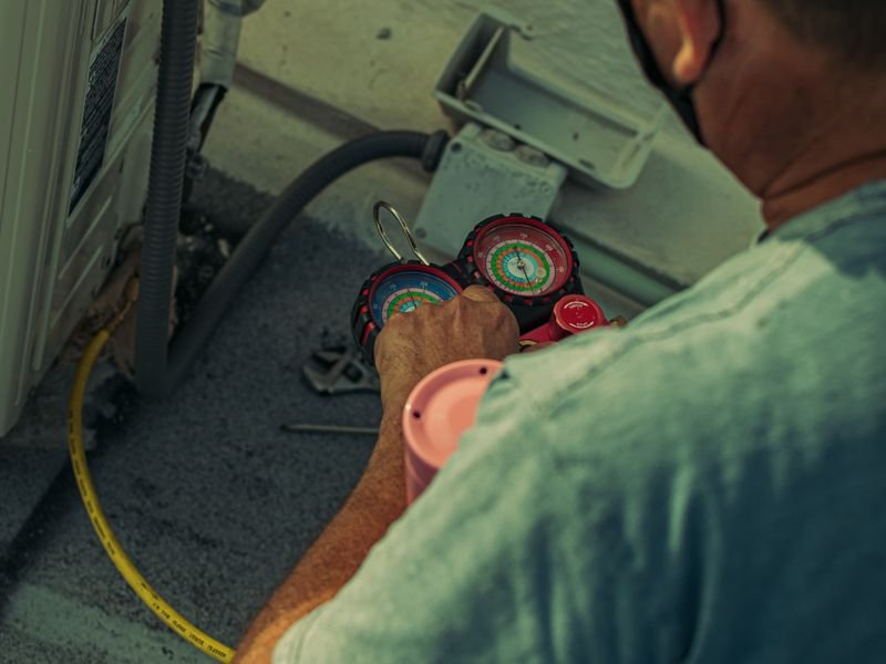 Engineer checking a home heating system with service gauges